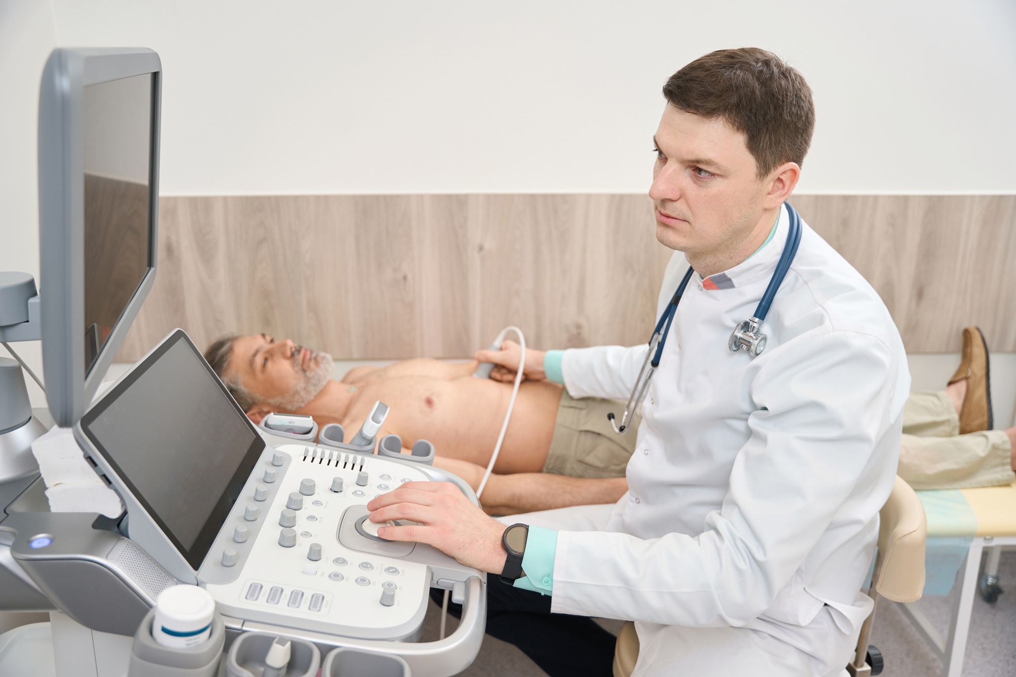 Doctor scanning internal organs of patient in the clinic